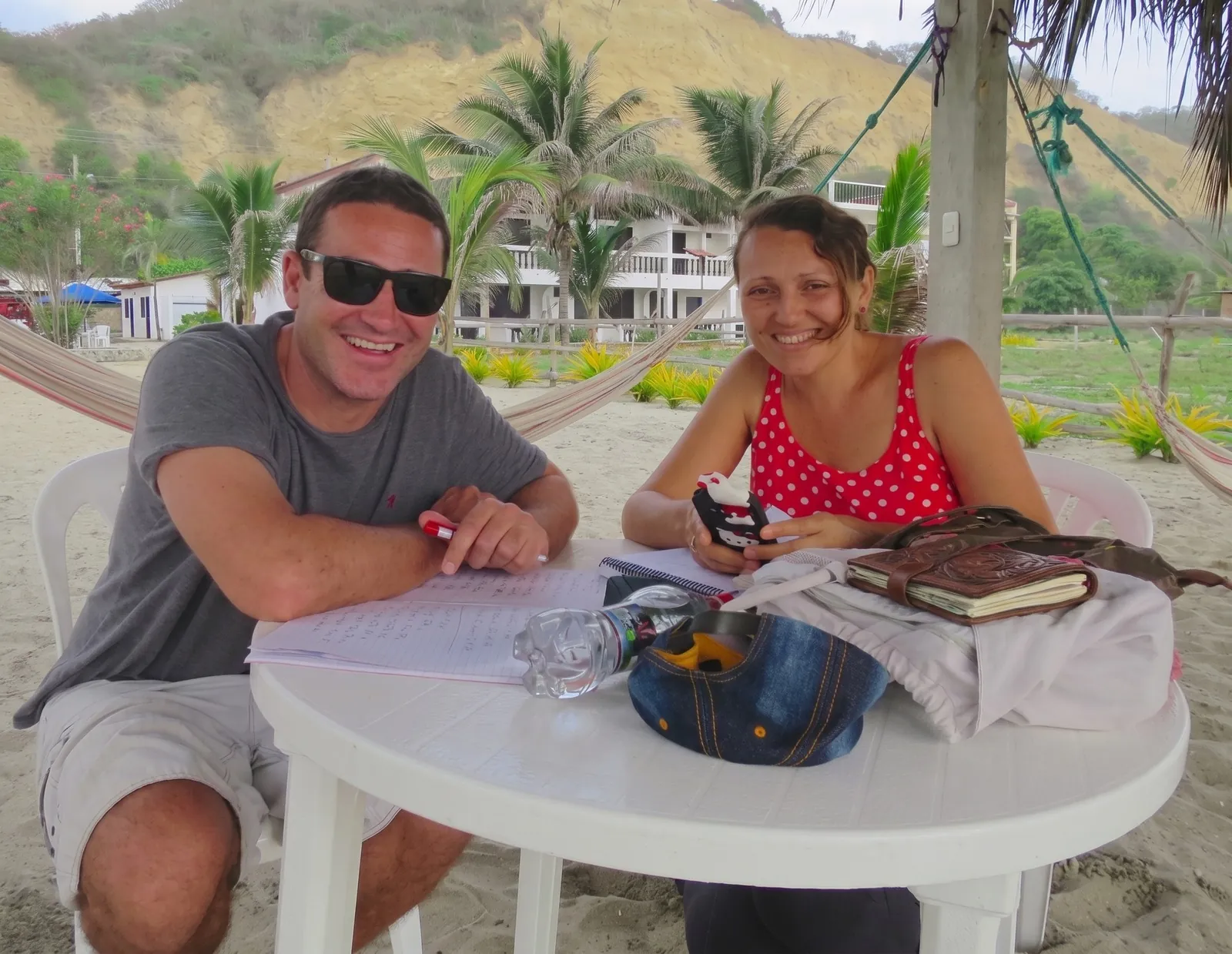 Teacher and student in a Spanish lesson beside the hammocks on Canoa beach
