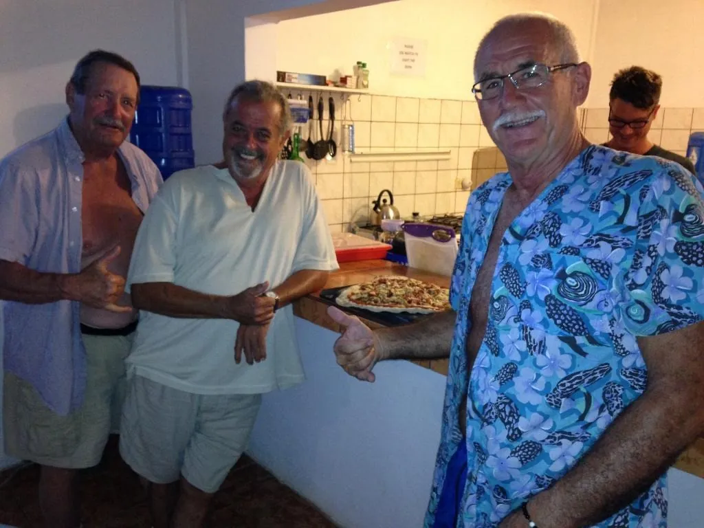 Guests sharing a homemade pizza in the hotel kitchen
